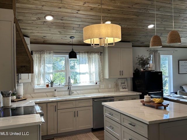 kitchen featuring dishwashing machine, a sink, freestanding refrigerator, and light stone countertops