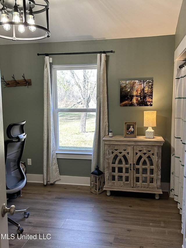 office area featuring an inviting chandelier, baseboards, and wood finished floors