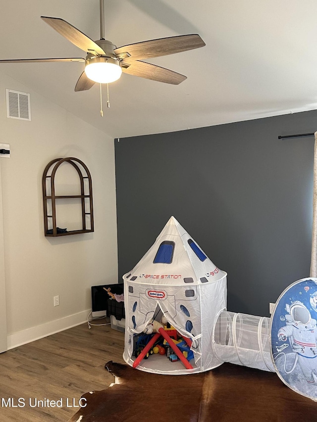 game room featuring a ceiling fan, wood finished floors, visible vents, and baseboards