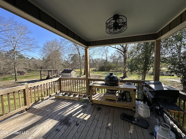 deck featuring a storage unit and an outdoor structure