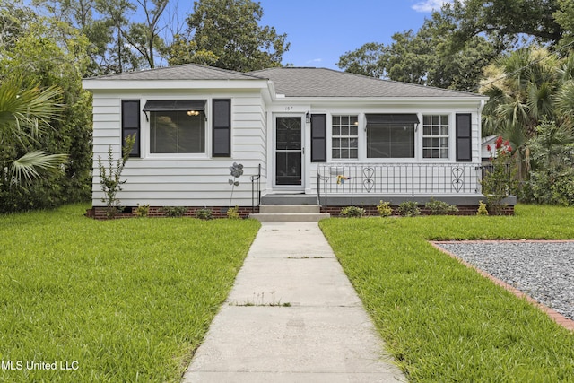 157 Saint Charles Ave, Biloxi, MS 39530 - bungalow featuring a front yard and roof with shingles