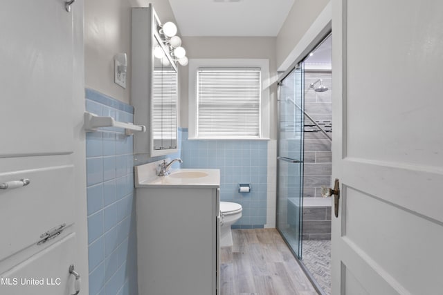 157 Saint Charles Ave, Biloxi, MS 39530 - full bath with tile walls, a shower stall, vanity, wood finished floors, and a wainscoted wall