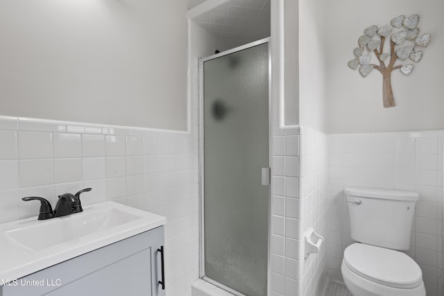 157 Saint Charles Ave, Biloxi, MS 39530 - full bathroom featuring tile walls, a stall shower, a wainscoted wall, and vanity