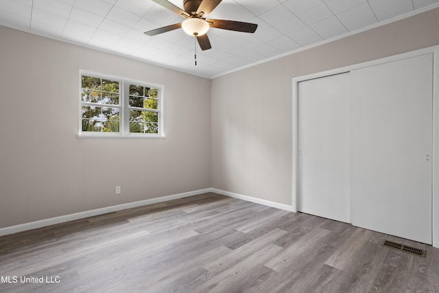 157 Saint Charles Ave, Biloxi, MS 39530 - unfurnished bedroom featuring wood finished floors, ornamental molding, a closet, and ceiling fan