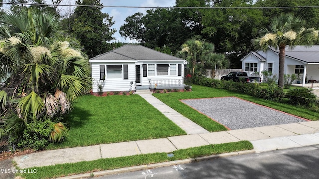 157 Saint Charles Ave, Biloxi, MS 39530 - view of front of property with a front lawn, a porch, and roof with shingles