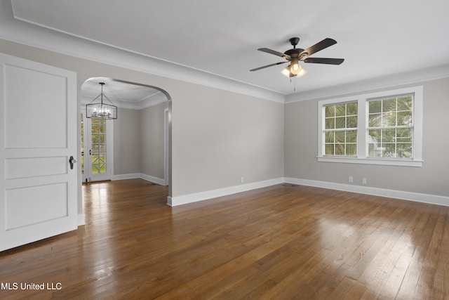 157 Saint Charles Ave, Biloxi, MS 39530 - empty room featuring a chandelier, arched walkways, dark wood-type flooring, ceiling fan, and ornamental molding