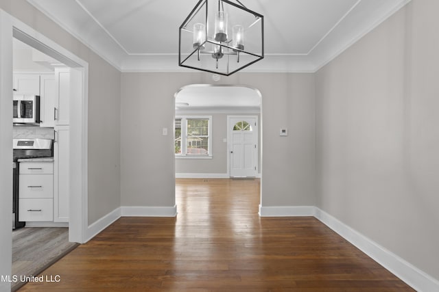 157 Saint Charles Ave, Biloxi, MS 39530 - unfurnished dining area featuring arched walkways, wood finished floors, a chandelier, and ornamental molding