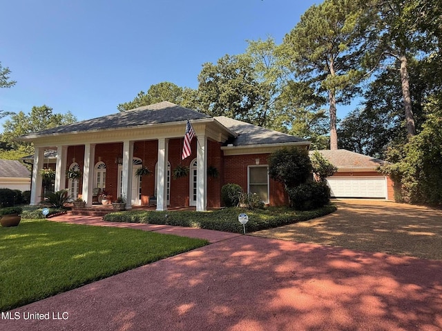 47 Avery Cir, Jackson, MS 39211 - greek revival house featuring a front yard, brick siding, and a garage
