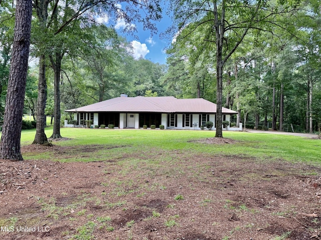 119 Chinquipin Ln, Florence, MS 39073 - view of front of home with a chimney, a front yard, a metal roof, and a view of trees