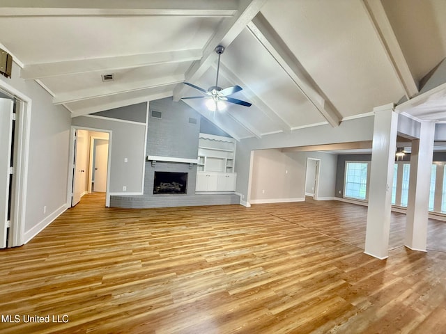119 Chinquipin Ln, Florence, MS 39073 - unfurnished living room featuring ceiling fan, light wood-style floors, and a fireplace