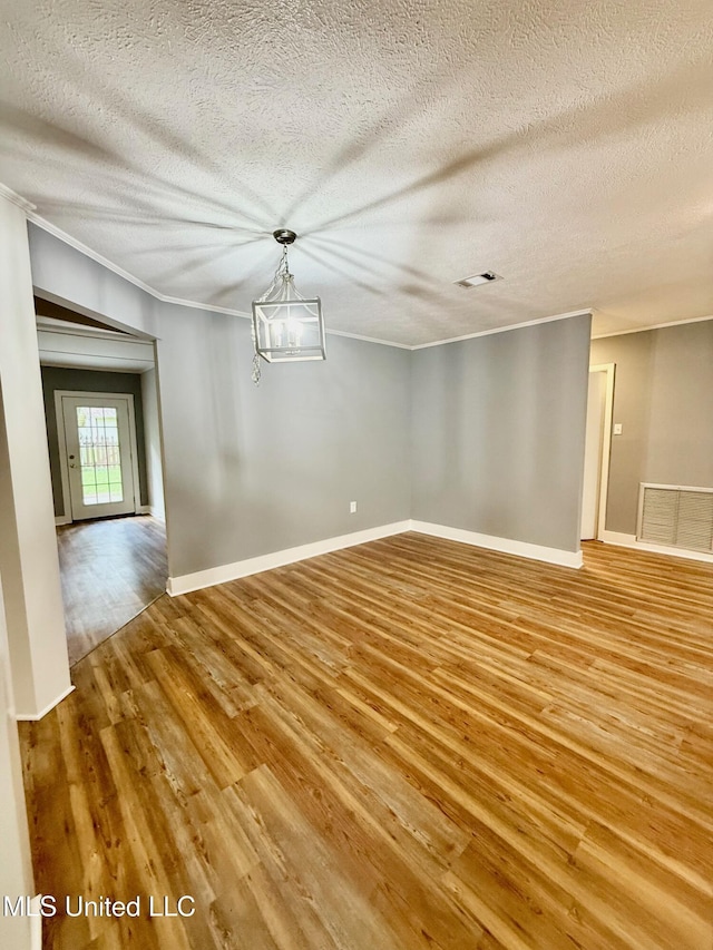 119 Chinquipin Ln, Florence, MS 39073 - unfurnished room with light wood-type flooring, ornamental molding, and a textured ceiling