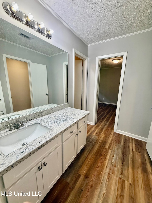 119 Chinquipin Ln, Florence, MS 39073 - bathroom with vanity, a textured ceiling, crown molding, and wood finished floors