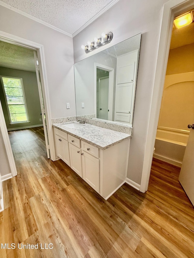119 Chinquipin Ln, Florence, MS 39073 - full bathroom featuring wood finished floors, vanity, a textured ceiling, and ornamental molding