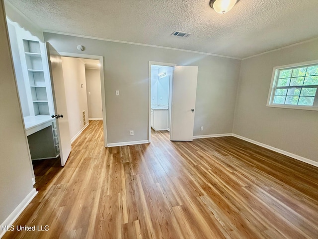 119 Chinquipin Ln, Florence, MS 39073 - unfurnished bedroom with a textured ceiling, crown molding, and wood finished floors