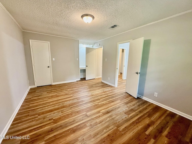 119 Chinquipin Ln, Florence, MS 39073 - empty room featuring a textured ceiling, ornamental molding, and light wood-type flooring