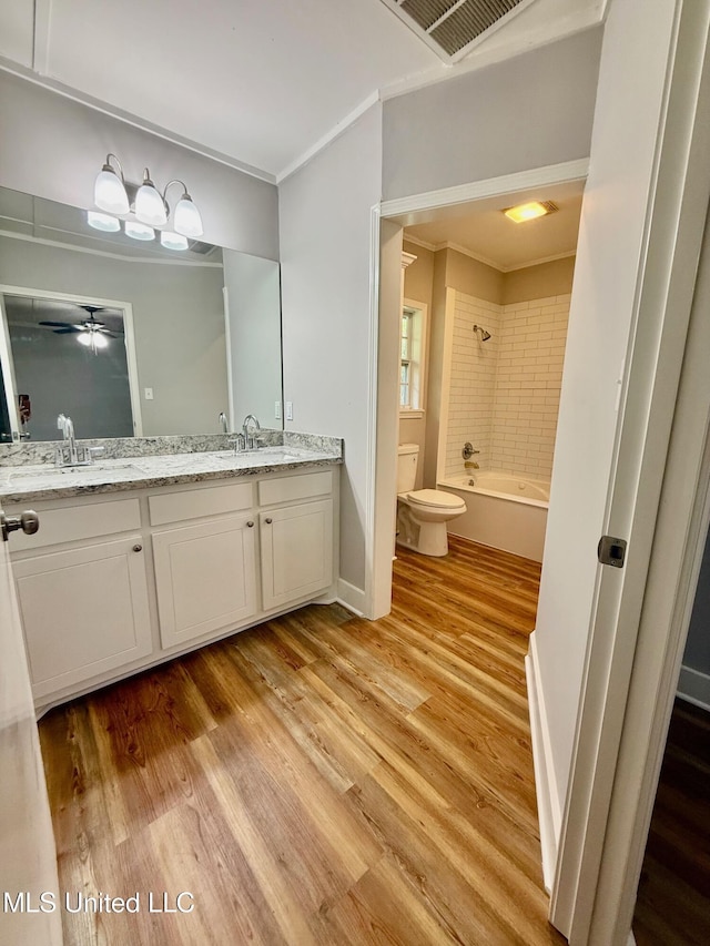 119 Chinquipin Ln, Florence, MS 39073 - bathroom with double vanity, wood finished floors, crown molding, washtub / shower combination, and a ceiling fan
