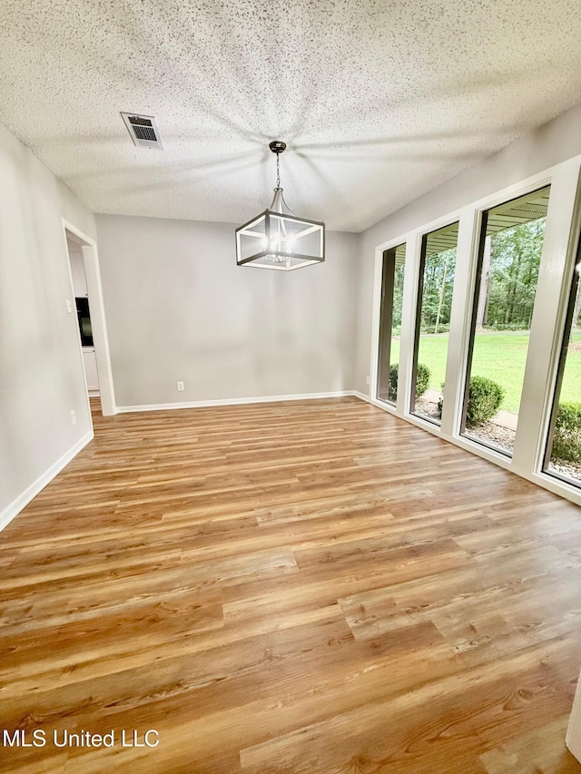 119 Chinquipin Ln, Florence, MS 39073 - unfurnished dining area featuring light wood-style floors and a textured ceiling