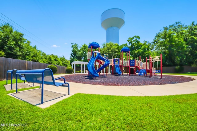 communal playground with fence and a lawn