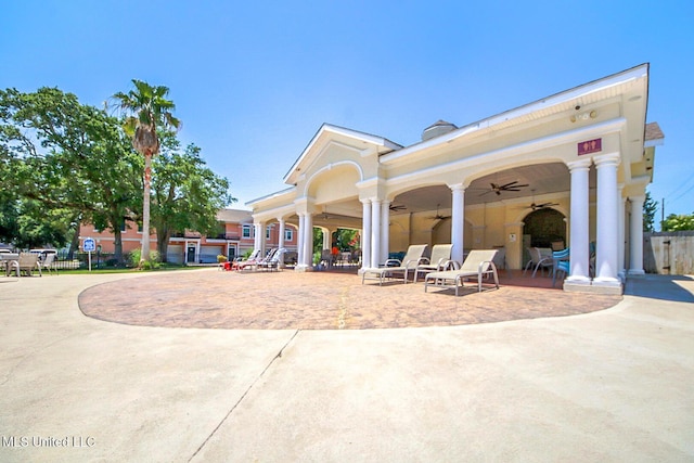 view of community featuring decorative driveway, a patio area, and fence