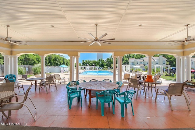 view of patio / terrace featuring a fenced in pool, outdoor dining space, fence, and ceiling fan