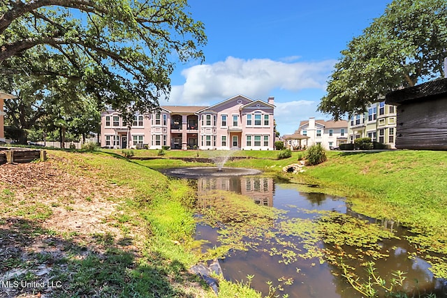 rear view of house featuring a water view