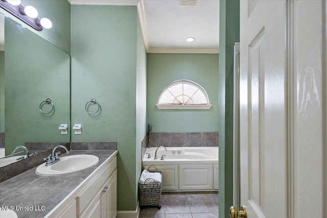 bathroom with vanity, tile patterned flooring, crown molding, and a tub