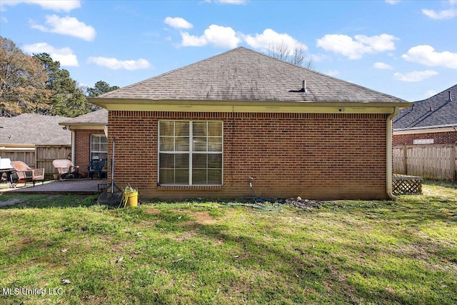 view of side of property with a yard and a patio