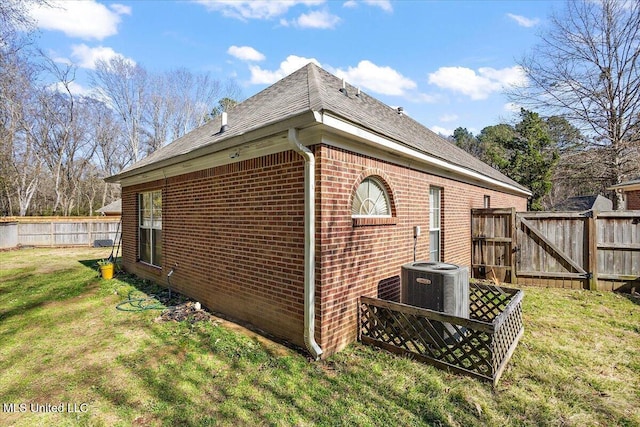 view of side of home with a yard and cooling unit