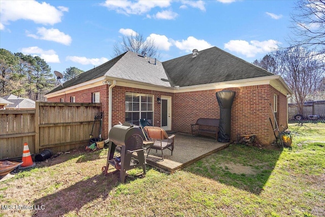 rear view of property with a patio and a lawn