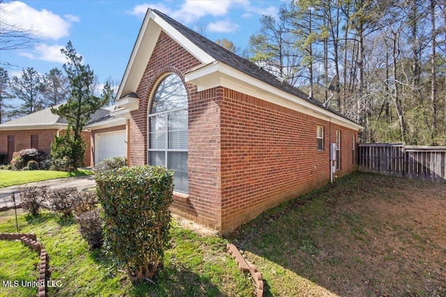 view of side of property featuring a yard and a garage