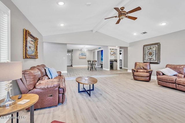 living area with visible vents, light wood-style flooring, a ceiling fan, baseboards, and vaulted ceiling with beams