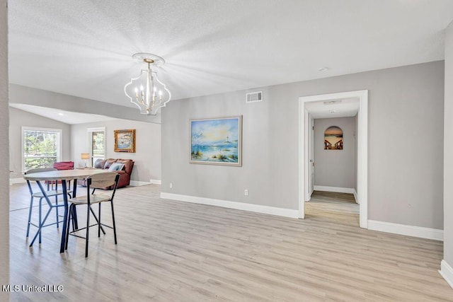 dining room with light wood-style floors, baseboards, and visible vents