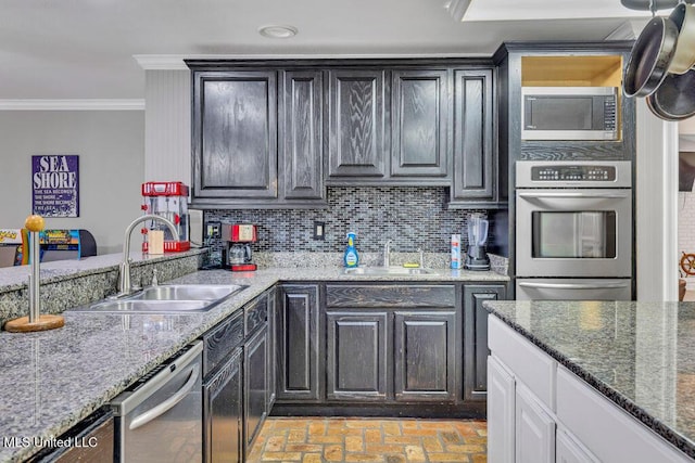 kitchen with a warming drawer, appliances with stainless steel finishes, crown molding, and a sink