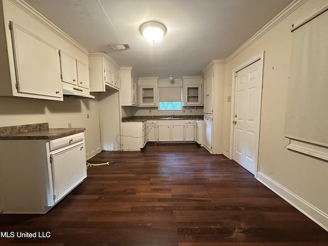 103 Lasalle St, Natchez, MS 39120 - kitchen featuring dark wood finished floors, white cabinetry, dark countertops, and glass insert cabinets