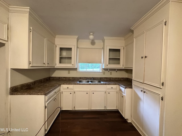 103 Lasalle St, Natchez, MS 39120 - kitchen with dark countertops, dark wood-style flooring, glass insert cabinets, white cabinetry, and crown molding