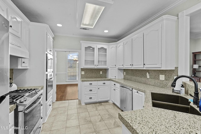 kitchen with sink, ornamental molding, white cabinets, and appliances with stainless steel finishes