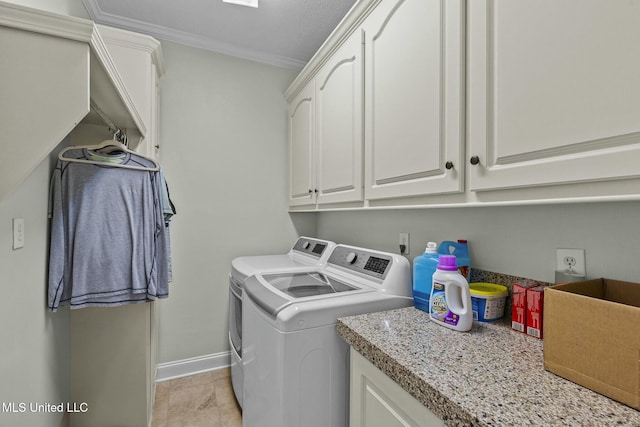 laundry room featuring crown molding, cabinets, and washing machine and dryer