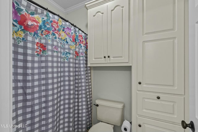 bathroom featuring ornamental molding and toilet