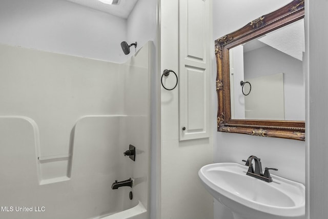 bathroom featuring  shower combination and sink