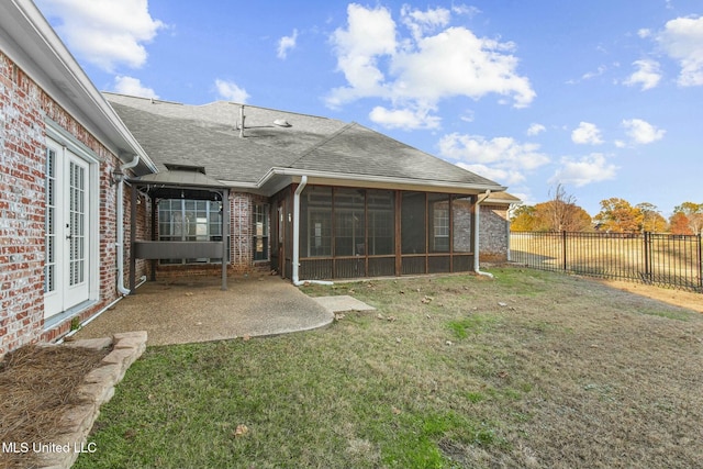 back of property featuring a gazebo, a sunroom, a lawn, and a patio