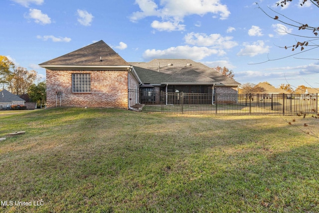 rear view of property featuring a yard