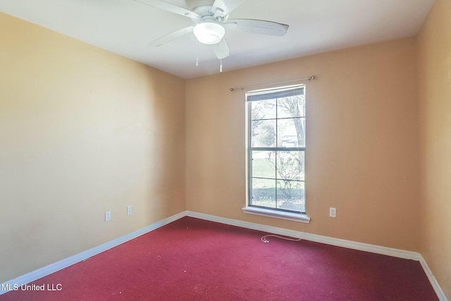 spare room with carpet floors, ceiling fan, and baseboards