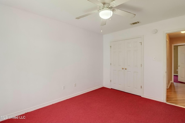 unfurnished bedroom with baseboards, a closet, visible vents, and carpet flooring