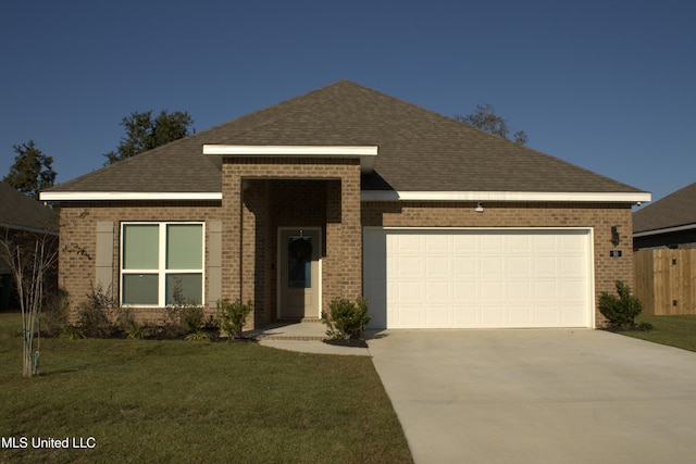 view of front of home featuring a garage and a front lawn