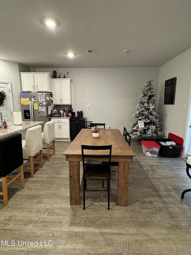 dining space featuring wood-type flooring