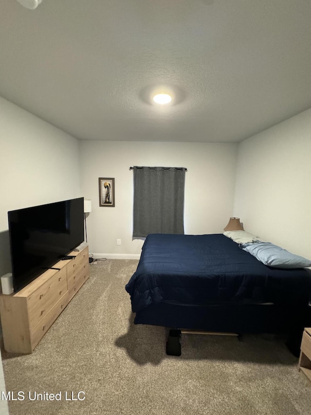 bedroom with carpet and a textured ceiling