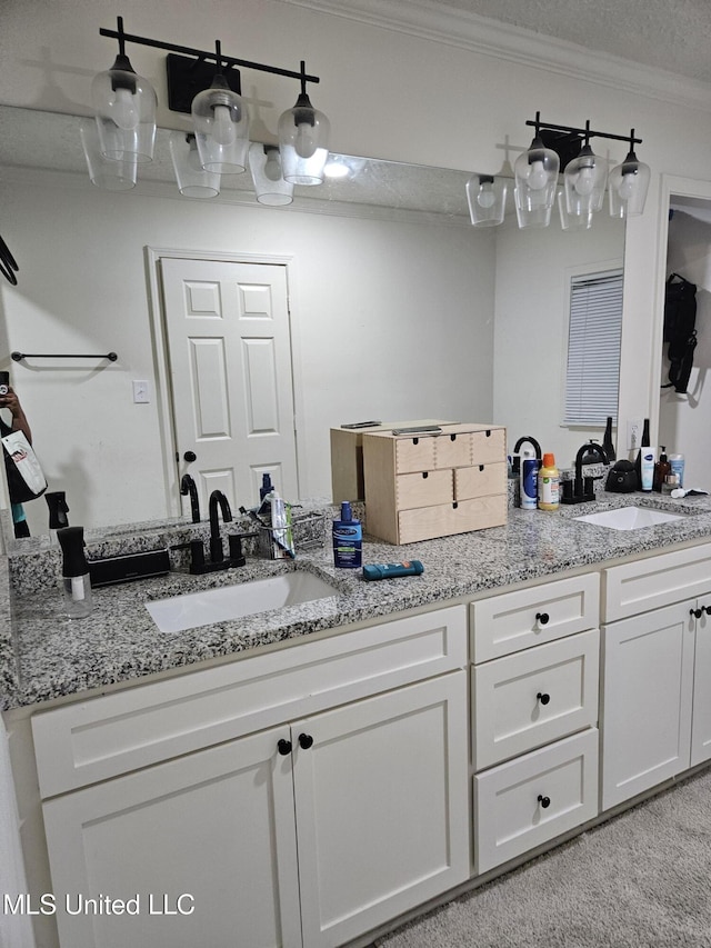 bathroom with double vanity, ornamental molding, and a sink