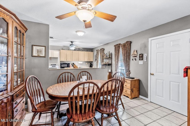 dining area featuring light tile patterned floors