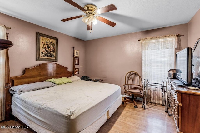 bedroom with light hardwood / wood-style flooring and ceiling fan