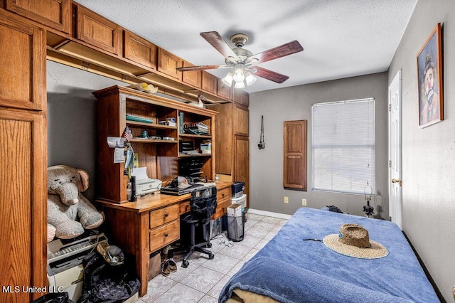 tiled bedroom with a textured ceiling and ceiling fan